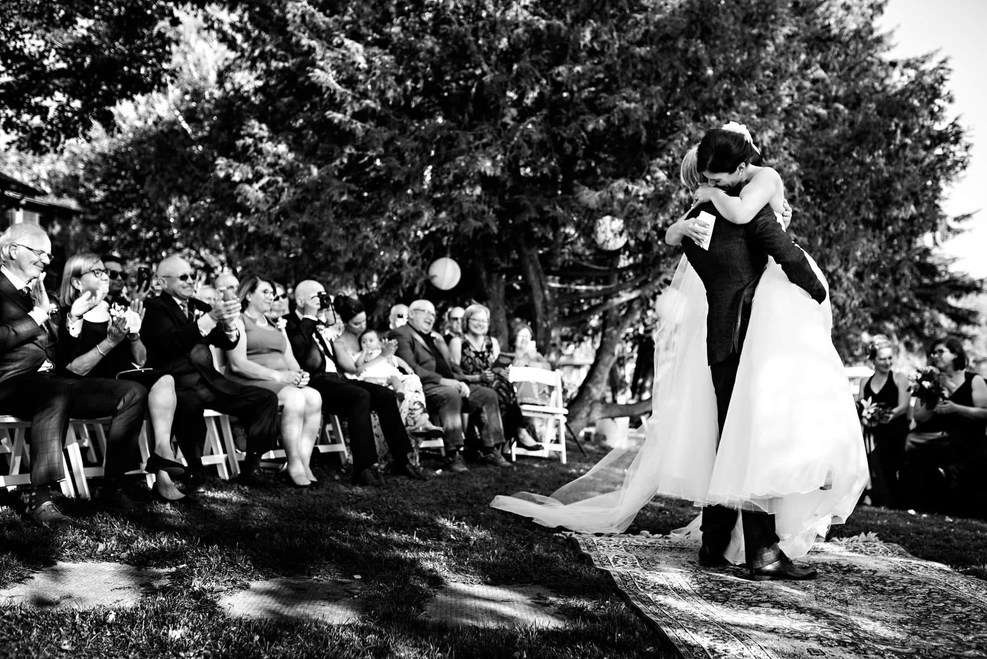 Bride hugs husband during wedding ceremony in Kenora