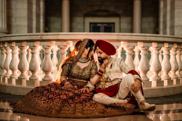 Sikh Wedding Traditions of a bride and groom in love sitting next to each other at the Sikh Society Indian Wedding
