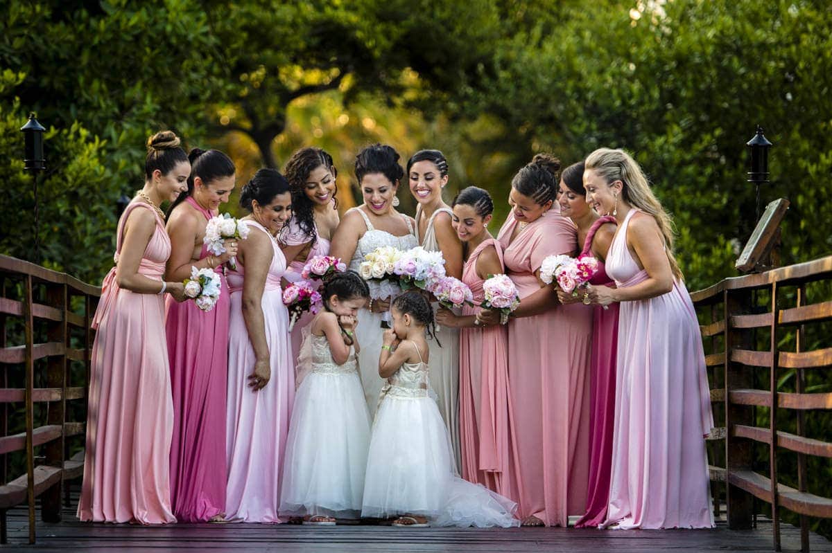 wedding costs in Winnipeg displaying a bride with her bridal party gathered around her.