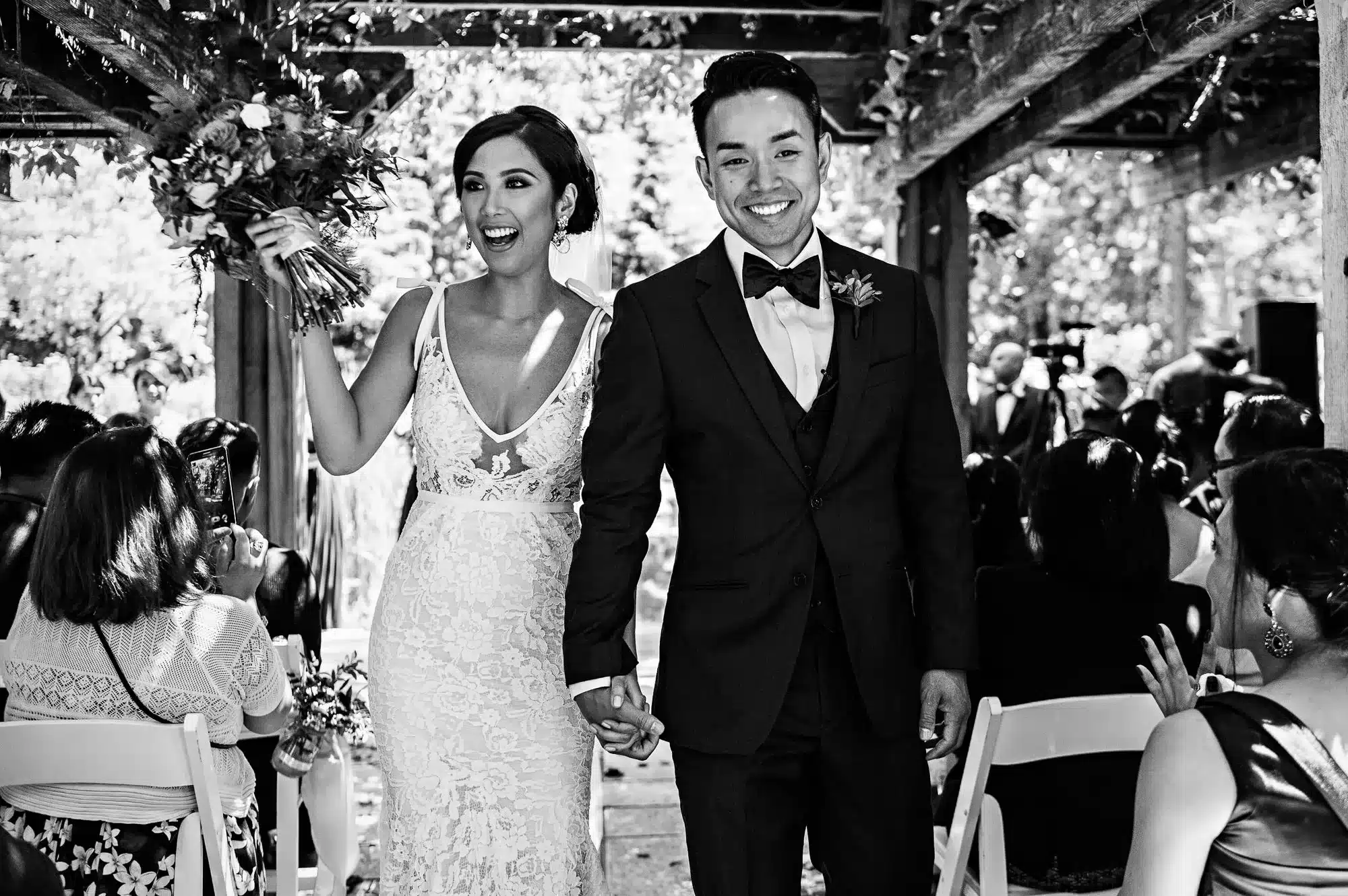 Winnipeg Wedding Photographer captures bride and groom after wedding ceremony walking down the aisle.